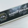 Boxed Suunto Vertical 2 Titanium Black smartwatch packaging shown at an angle with a partial image of the watch face on the left.