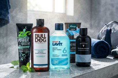 Assorted men’s grooming products lined up on a wet bathroom counter, including Bull-Dull body wash and Lavit ice-fit shower gel.