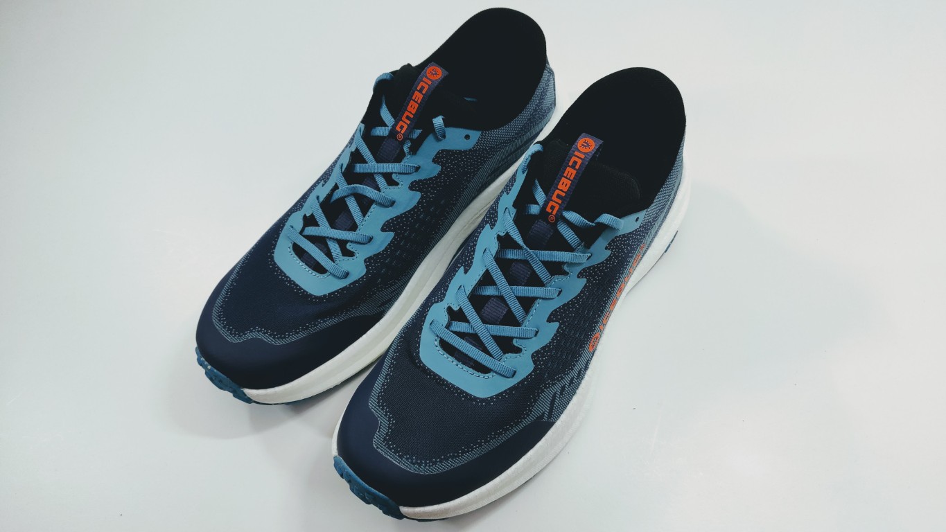 Pair of Icebug navy running shoes with teal/lake-blue laces and white midsoles on a light background, angled for display.