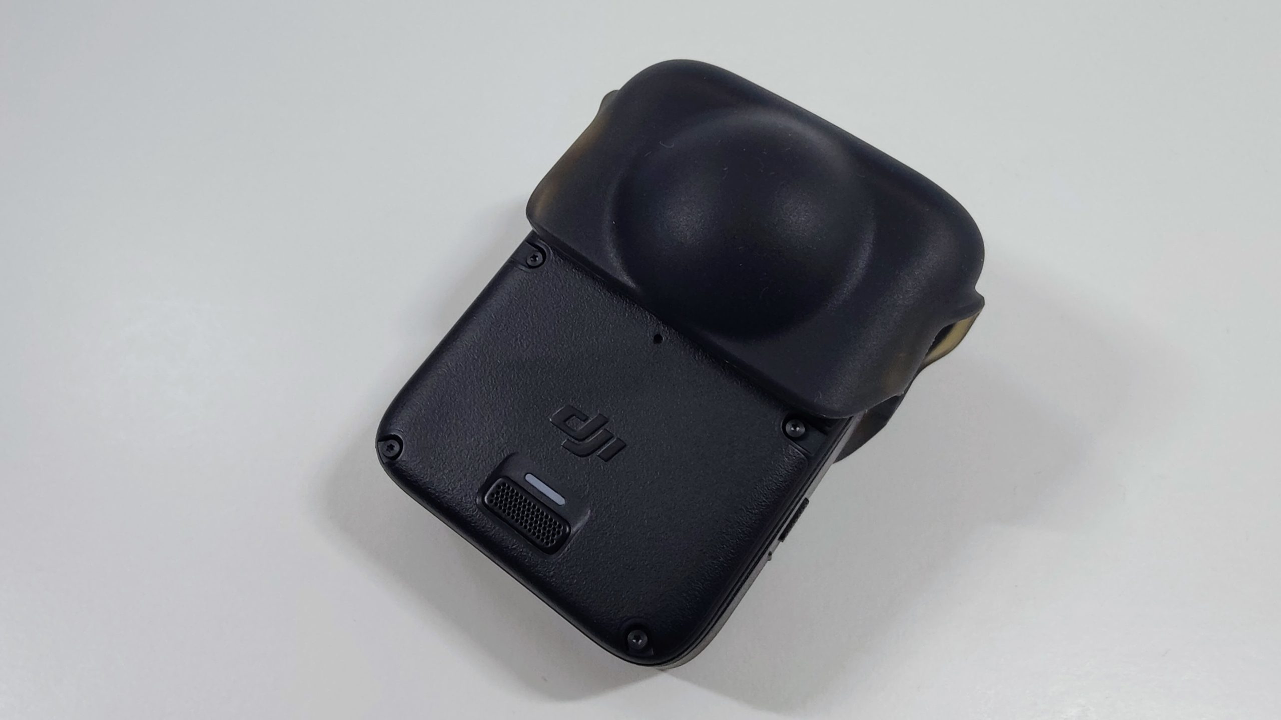 Black 360 camera with a protective silicone lens cap fitted over the lens.