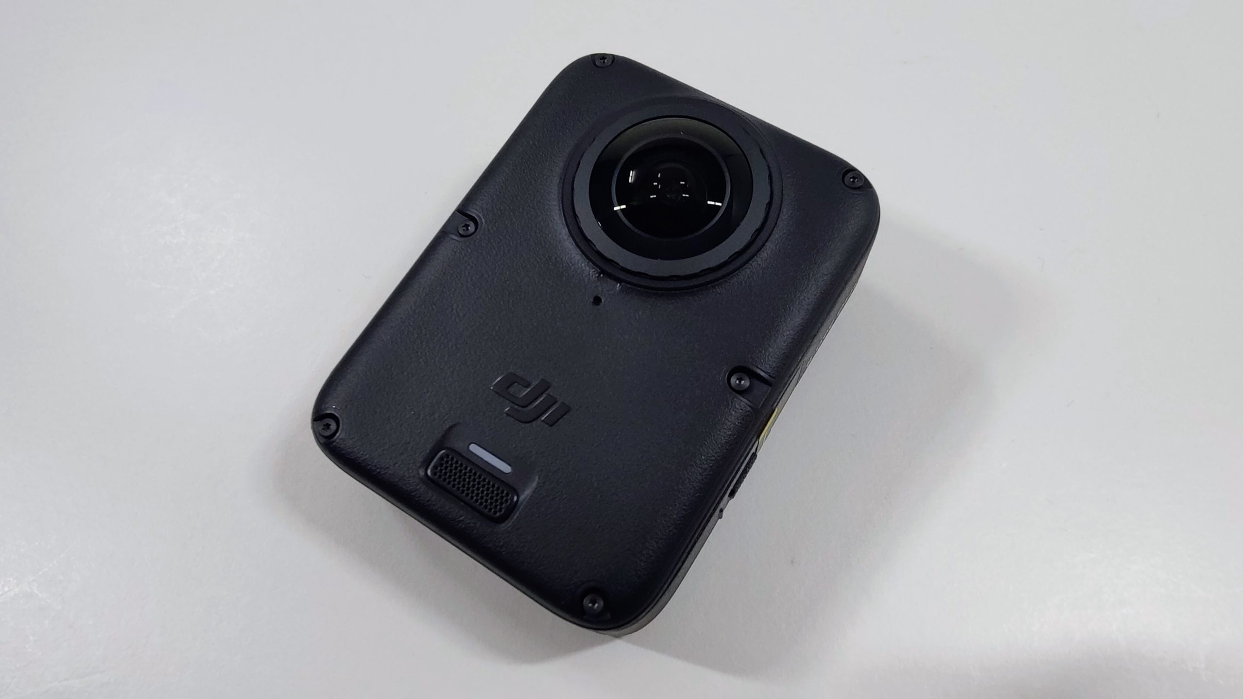Back of the 360 camera with a single large fisheye lens and DJI logo.